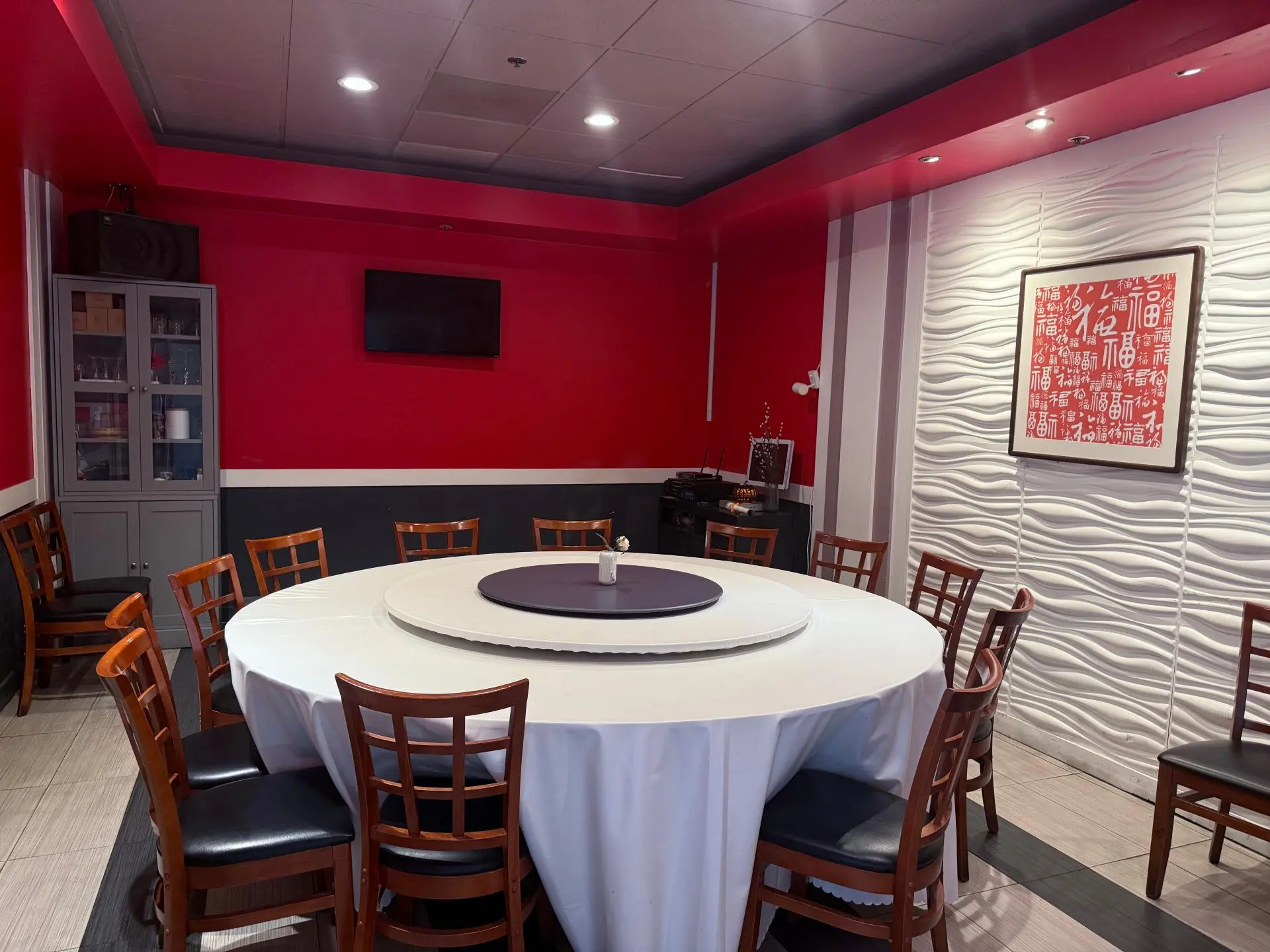 Dining space with Sichuan - themed wall art and round tables at Spices Garden, a Chines Sichuan Restaurant in Fremont